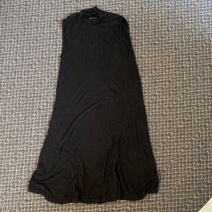 Knee length high neck sleeveless black dress.